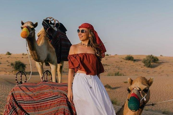 Experience the serene beauty of the desert landscape while enjoying a close encounter with camels perfect for a memorable sunset safari and BBQ dinner under the sky.